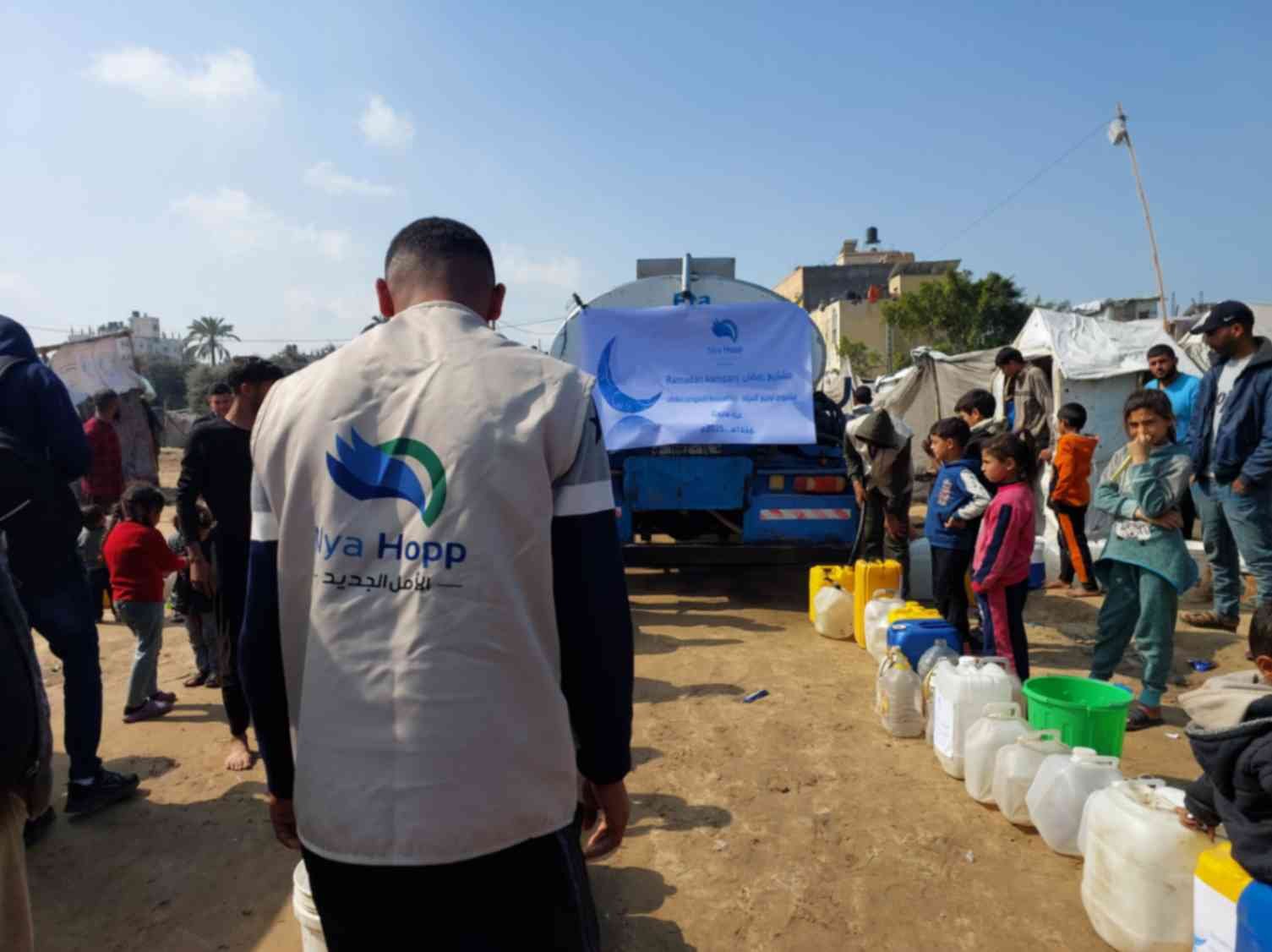 Gaza families receiving clean water from Nya Hopp during humanitarian crisis.